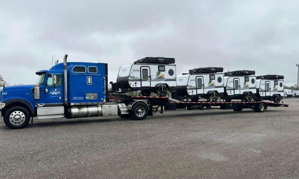 Blue truck hauling trailers